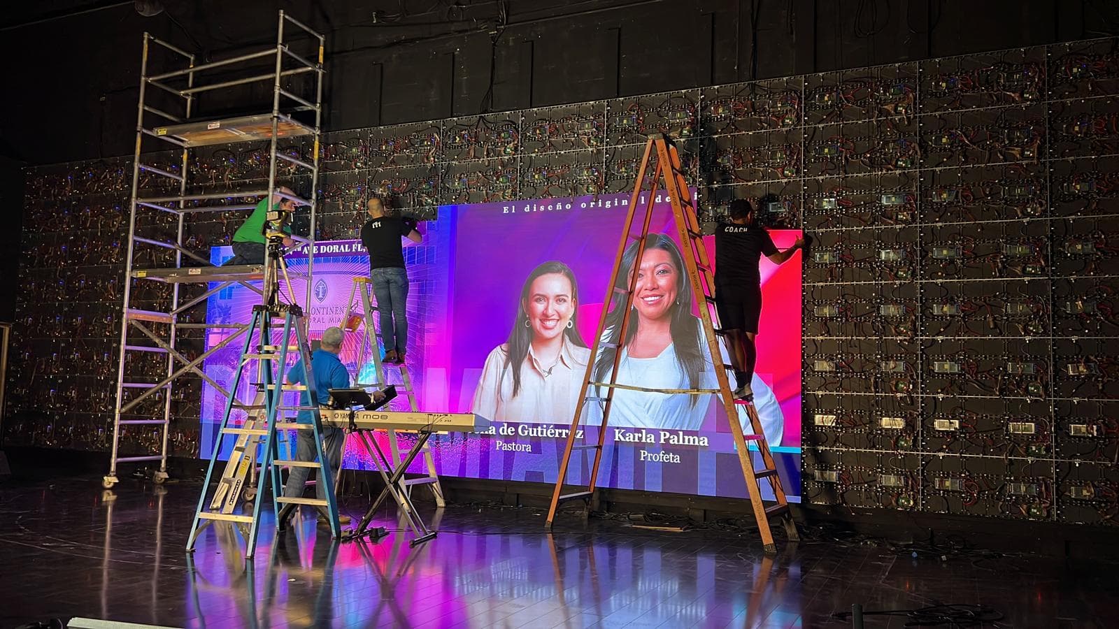Technicians installing LED display panels for church stage backdrop